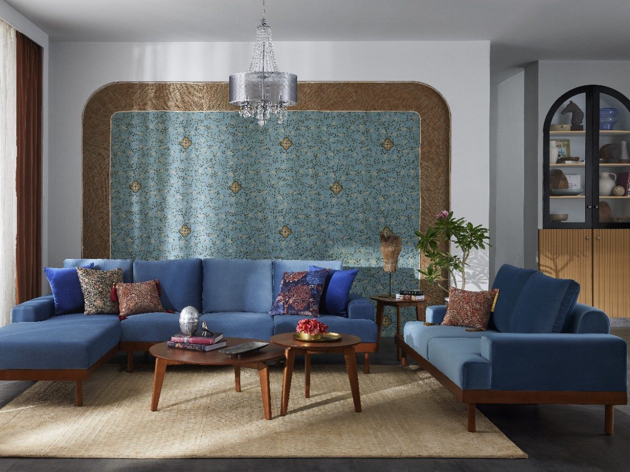 Traditional living room with blue sofa set and floral wall panel - Beautiful Homes
