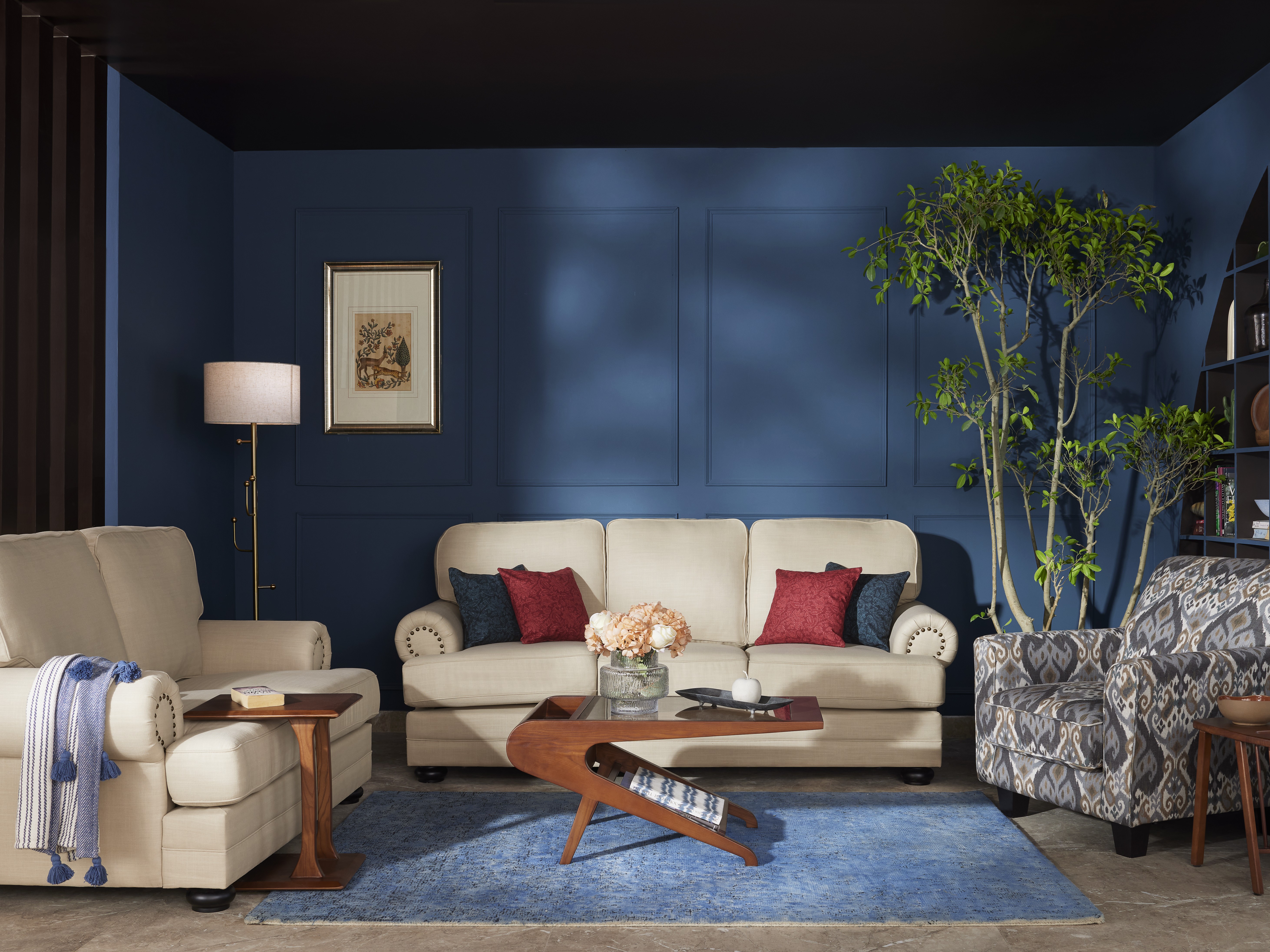Living room with beige sofa and blue wall - Beautiful Homes