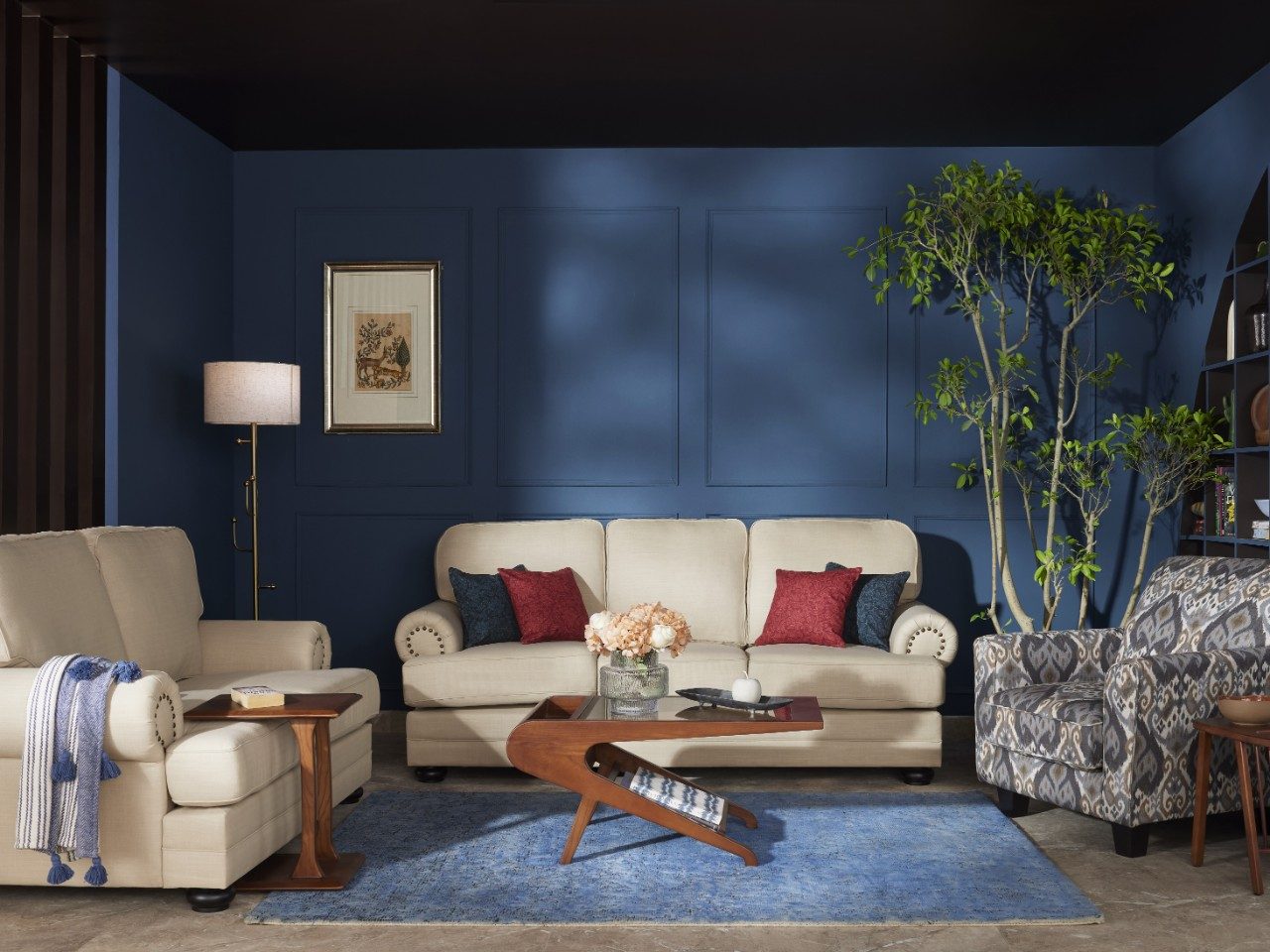 Living room with beige sofa and blue wall - Beautiful Homes