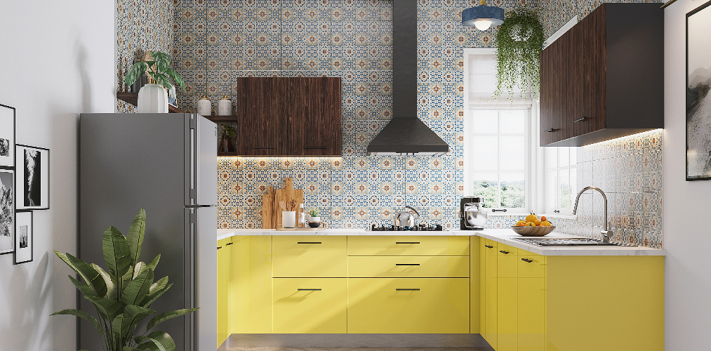 C shaped kitchen with designer wall tiles & yellow cabinets-Beautiful Homes