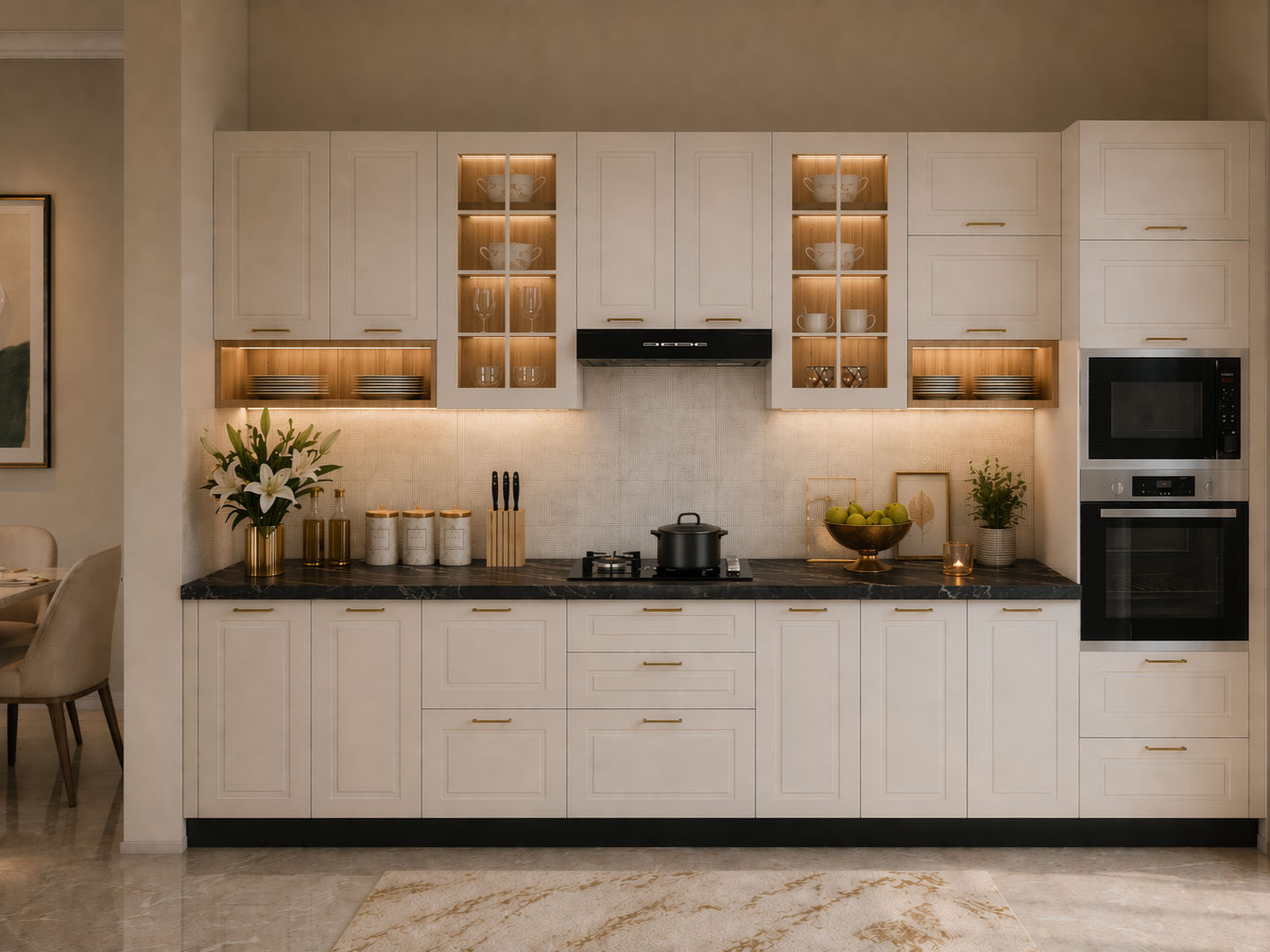 Modern kitchen with off-white shaker cabinets, gold handles, black marble countertops with white veining, illuminated glass-front storage, and built-in ovens on the right side - Beautiful Homes