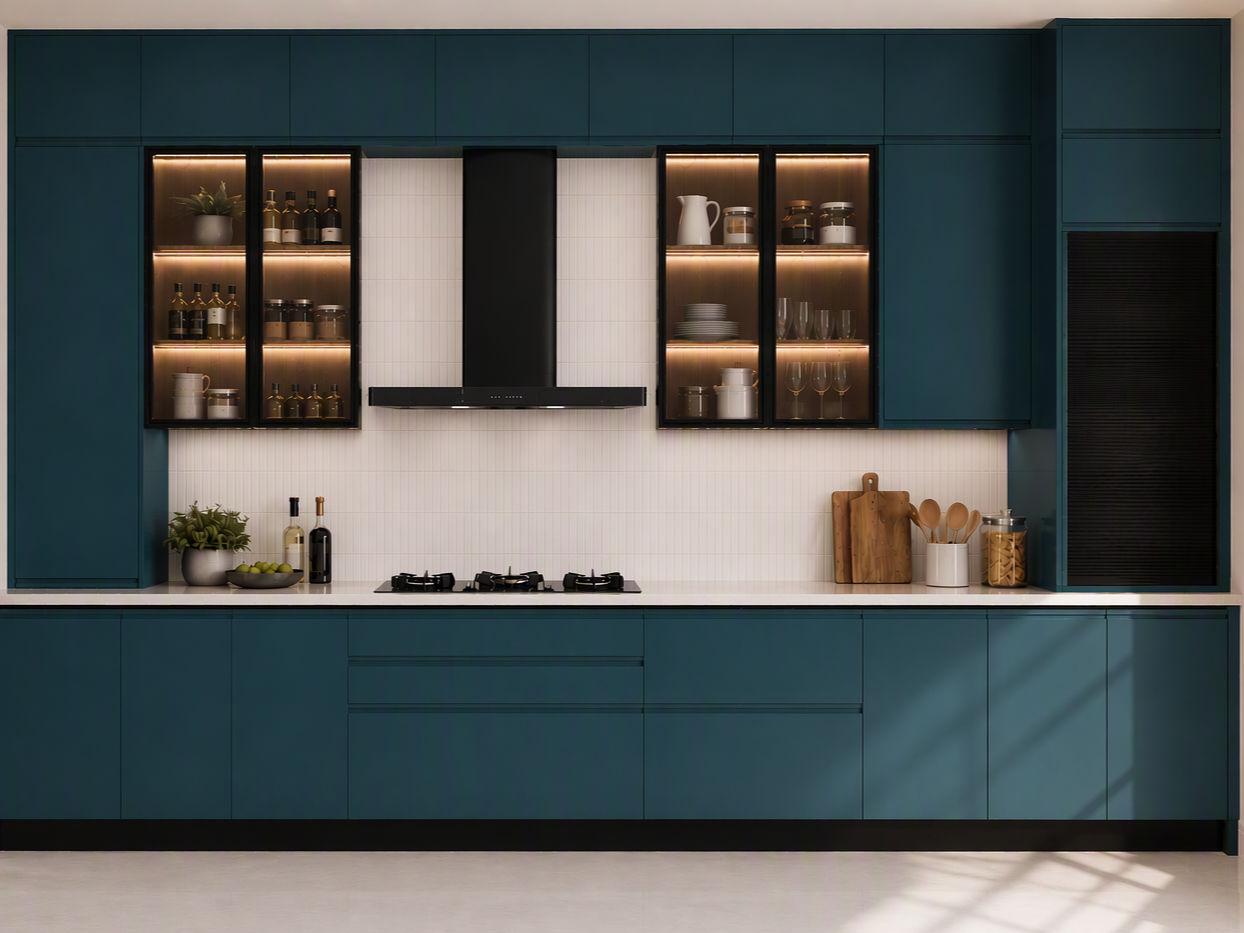 Modern teal-blue modular kitchen featuring illuminated glass display cabinets and a white tiled backsplash - Beautiful Homes