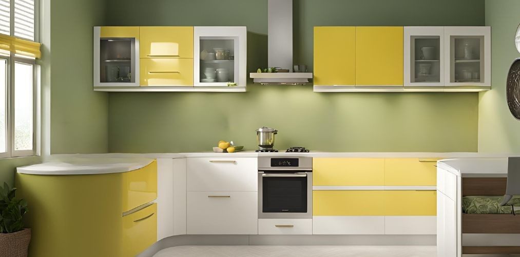 Classic yellow and white modular kitchen with sage green accent wall - Beautiful Homes