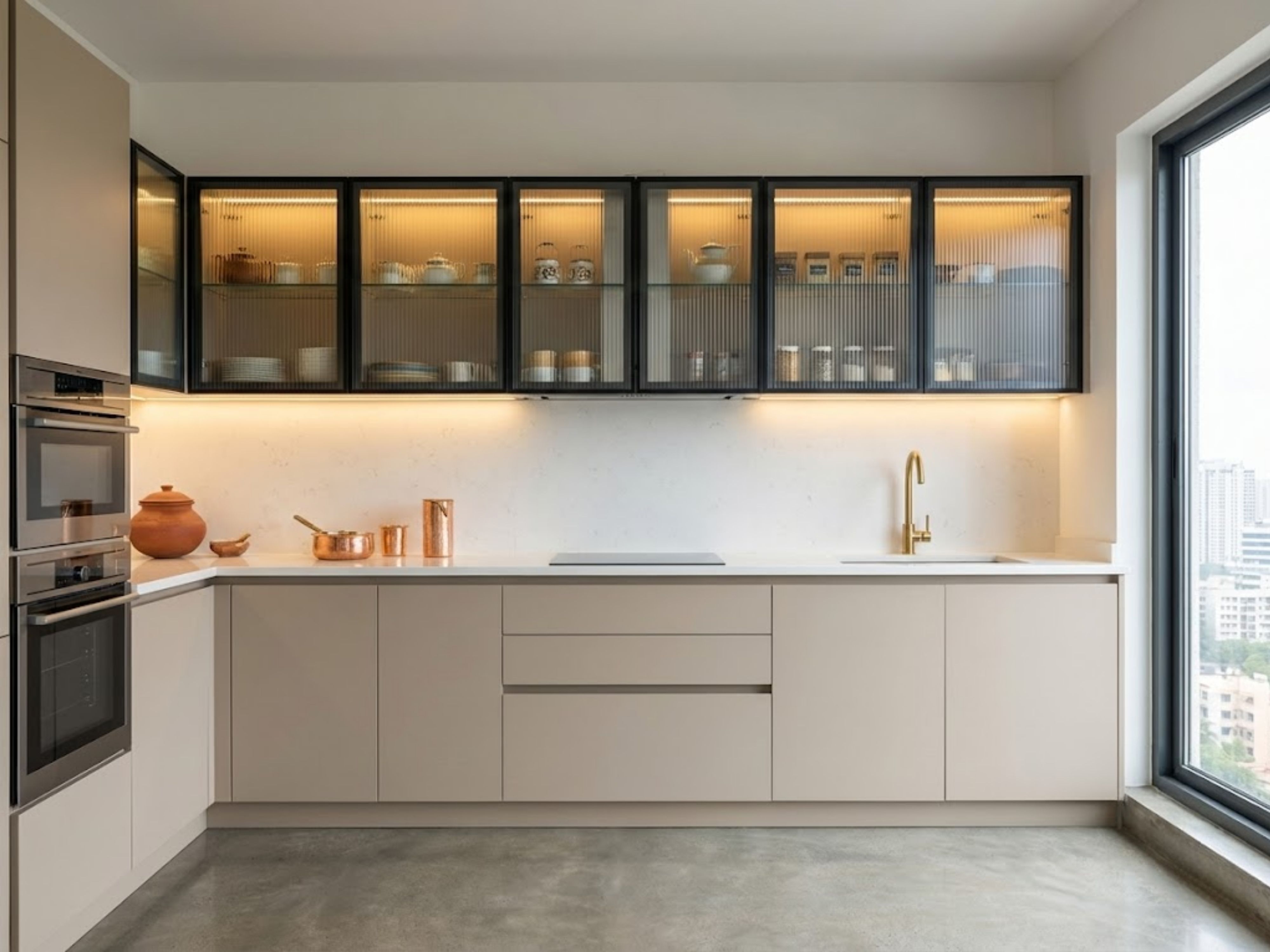 Modern kitchen with beige cabinets and golden faucet - Beautiful Homes