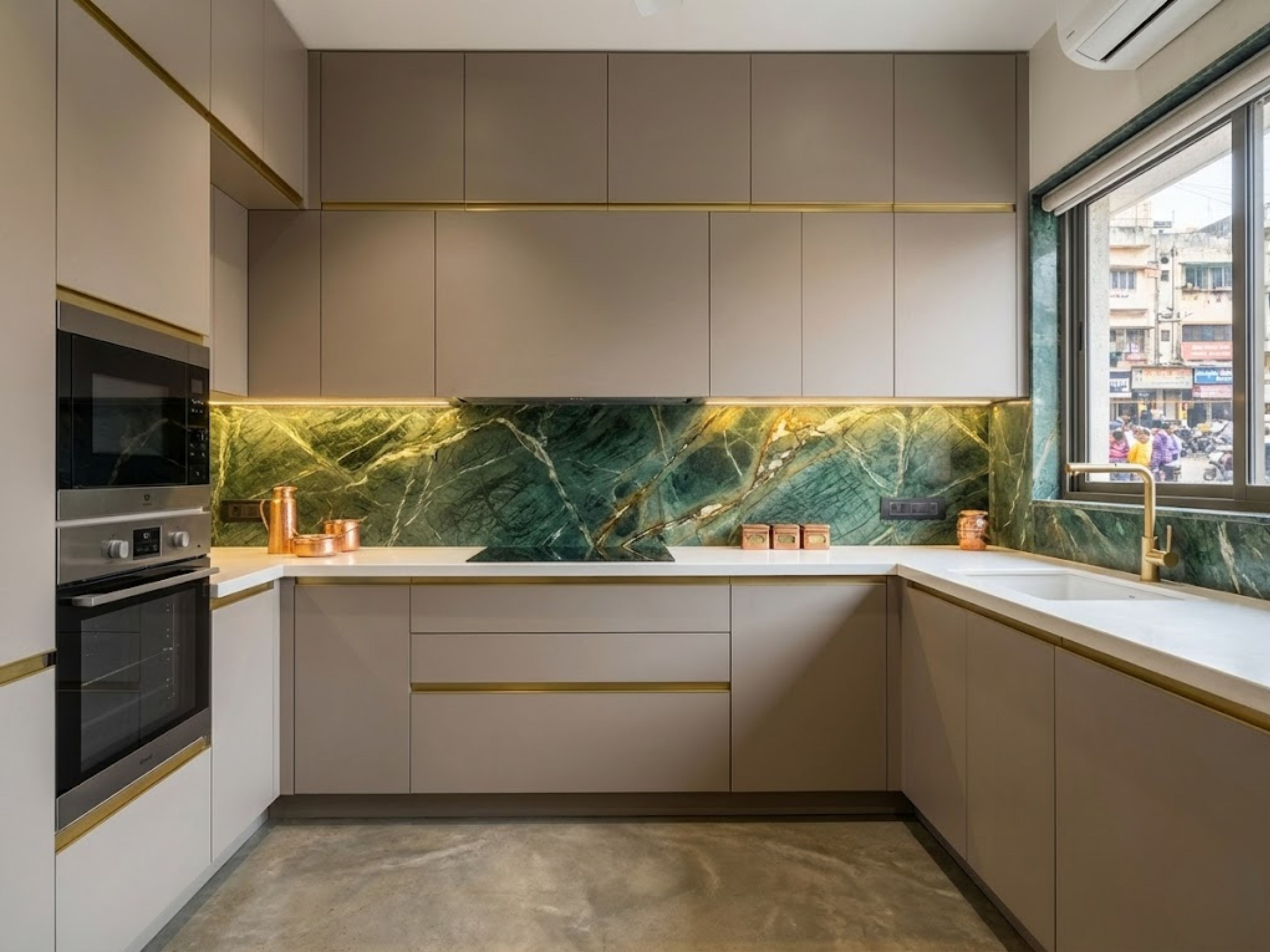 Modern kitchen with green marble backsplash and brass accents - Beautiful Homes