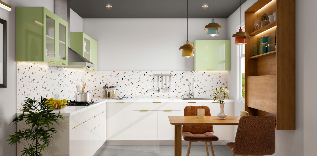 White l shaped kitchen design with pastel green cabinets & breakfast nook-Beautiful Homes