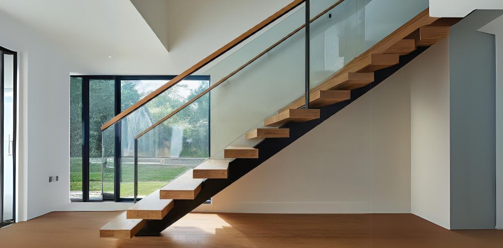 Glass railing with wooden rail top for a cantilever staircase - Beautiful Homes