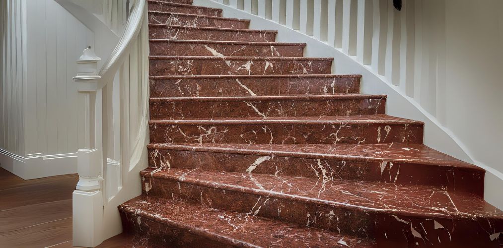 Red granite staircase with white wood railing - Beautiful Homes