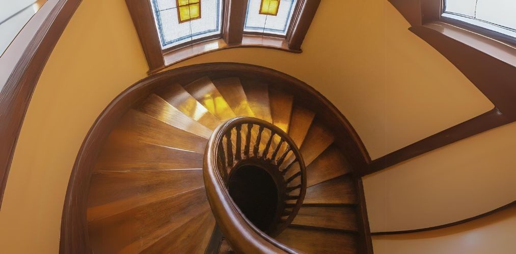 Spiral wooden staircase with traditional balusters - Beautiful Homes