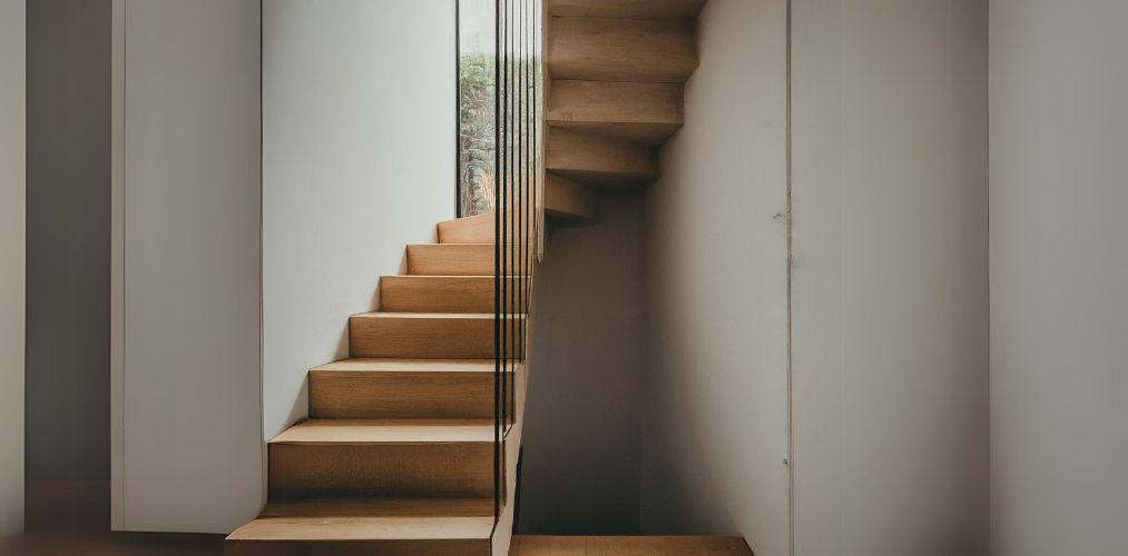 Wooden staircase in a small corner with metal partition - Beautiful Homes