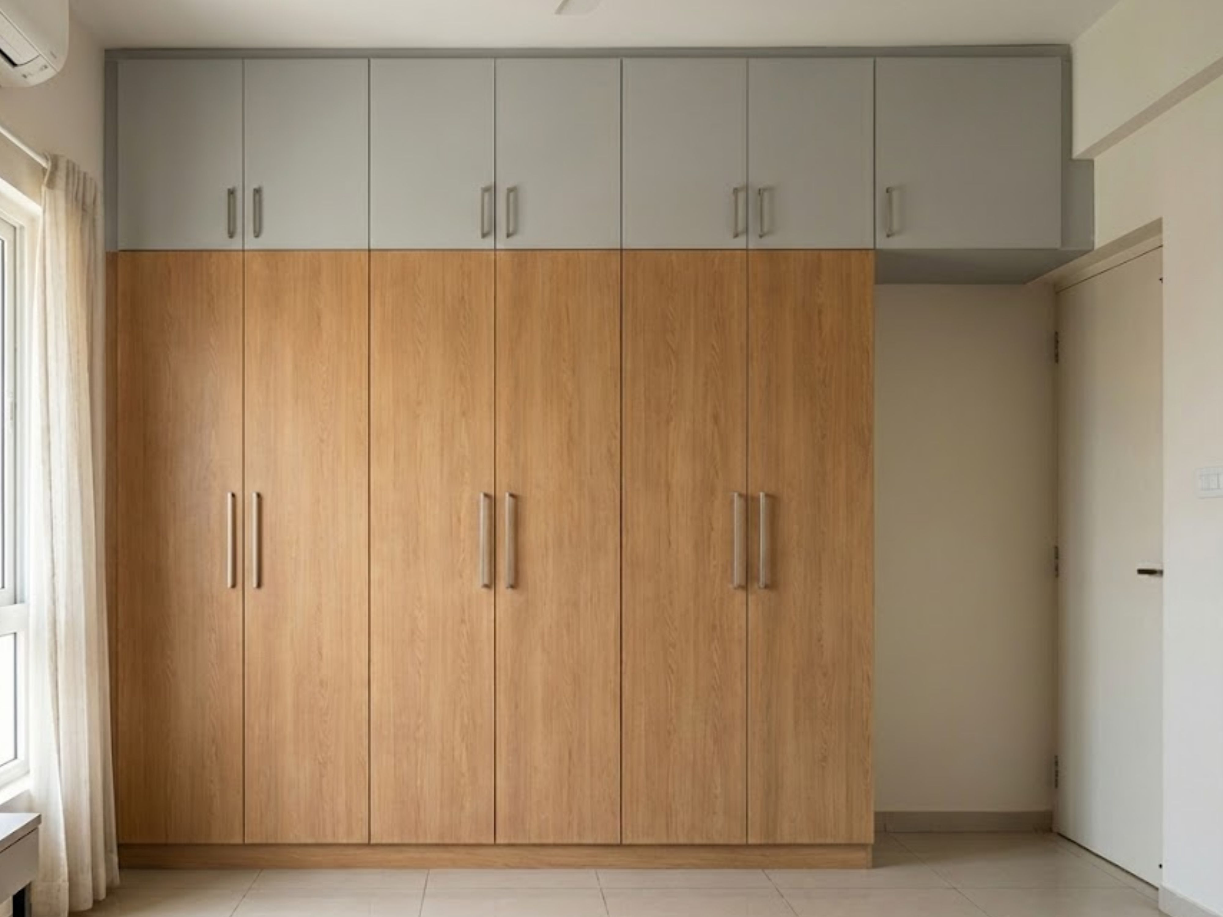 Wooden wardrobe with grey top cabinets and sleek handles - Beautiful Homes