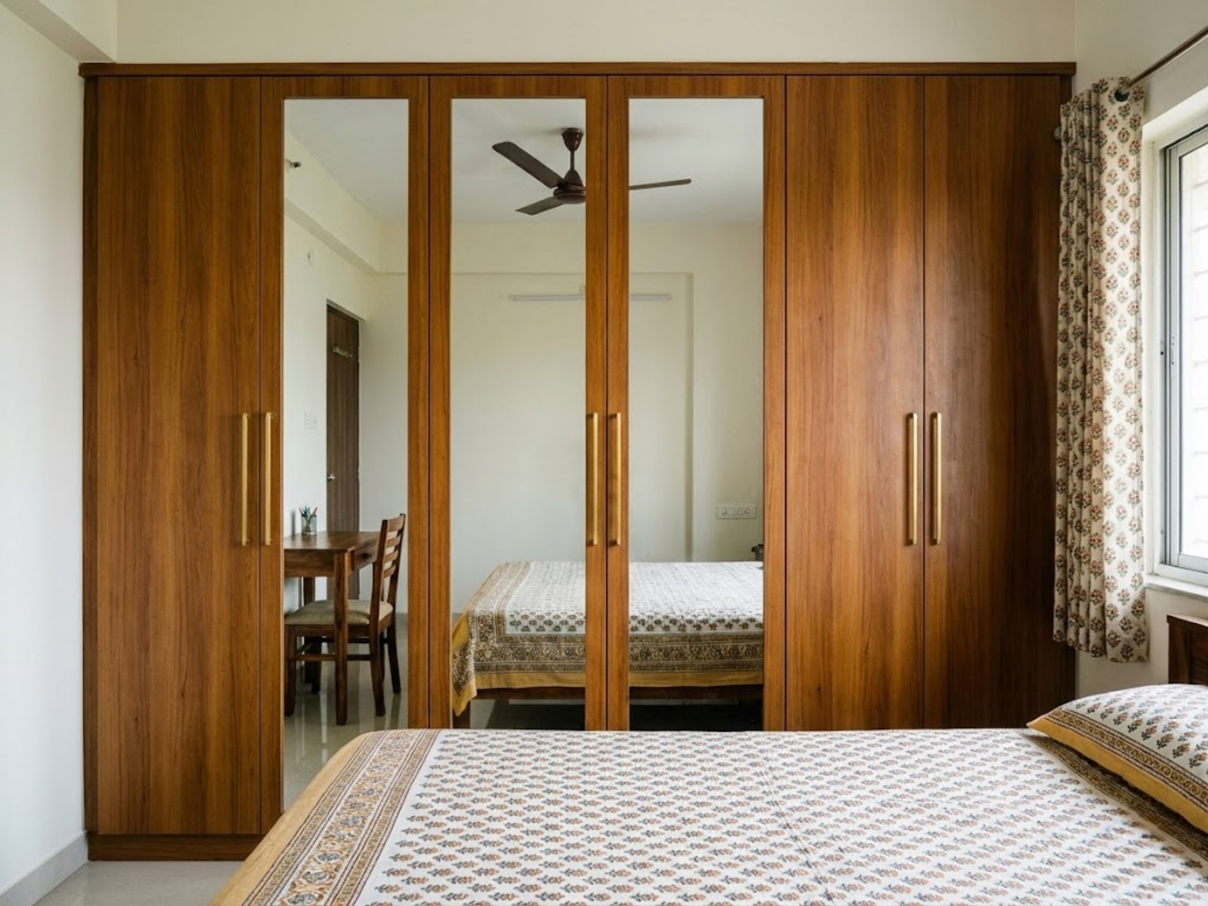 Wooden wardrobe with mirrors in a cozy bedroom - Beautiful Homes