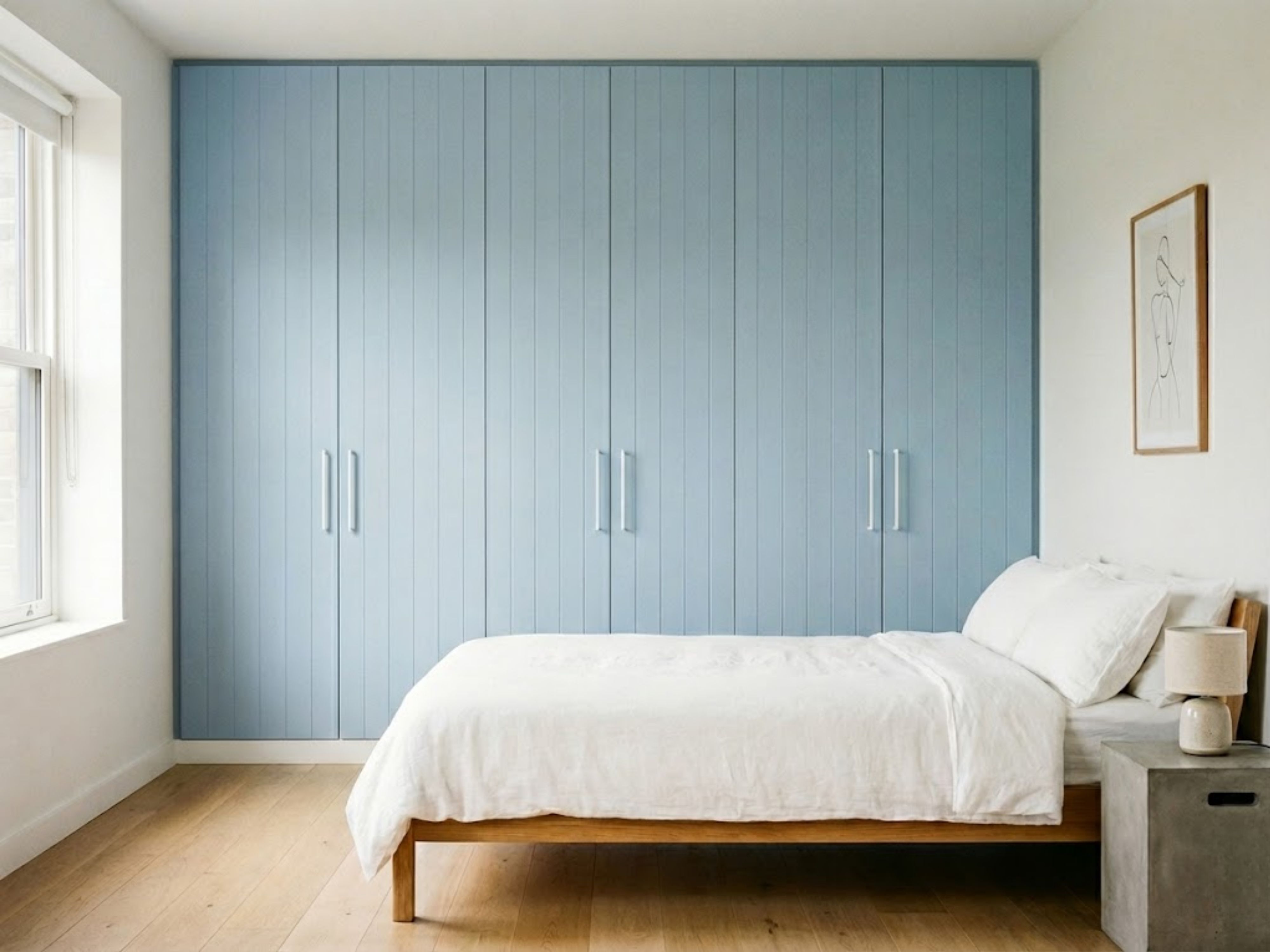 Bedroom with blue wardrobe and wooden bed frame - Beautiful Homes