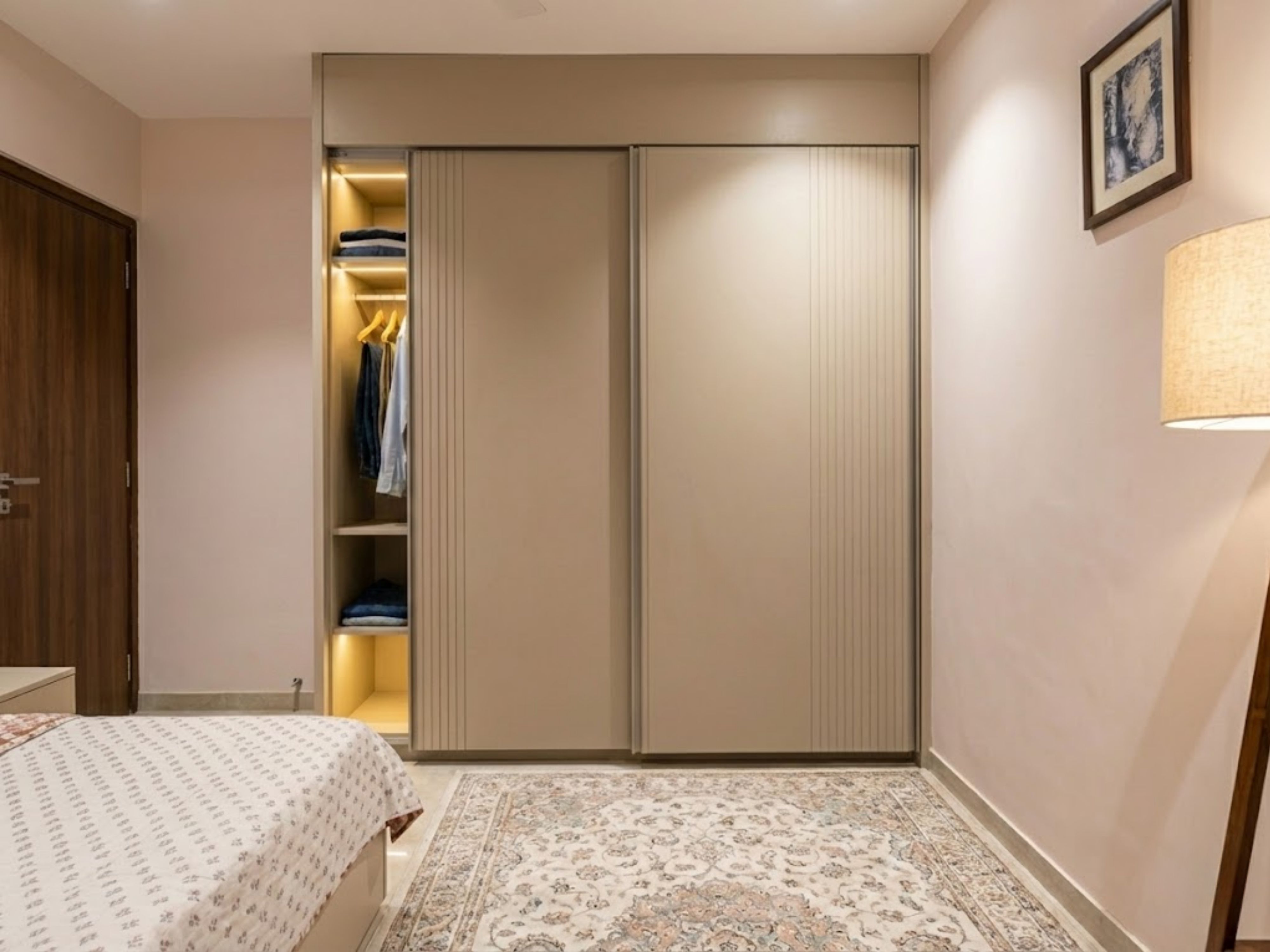 Modern beige wardrobe with sliding doors and lighting - Beautiful Homes