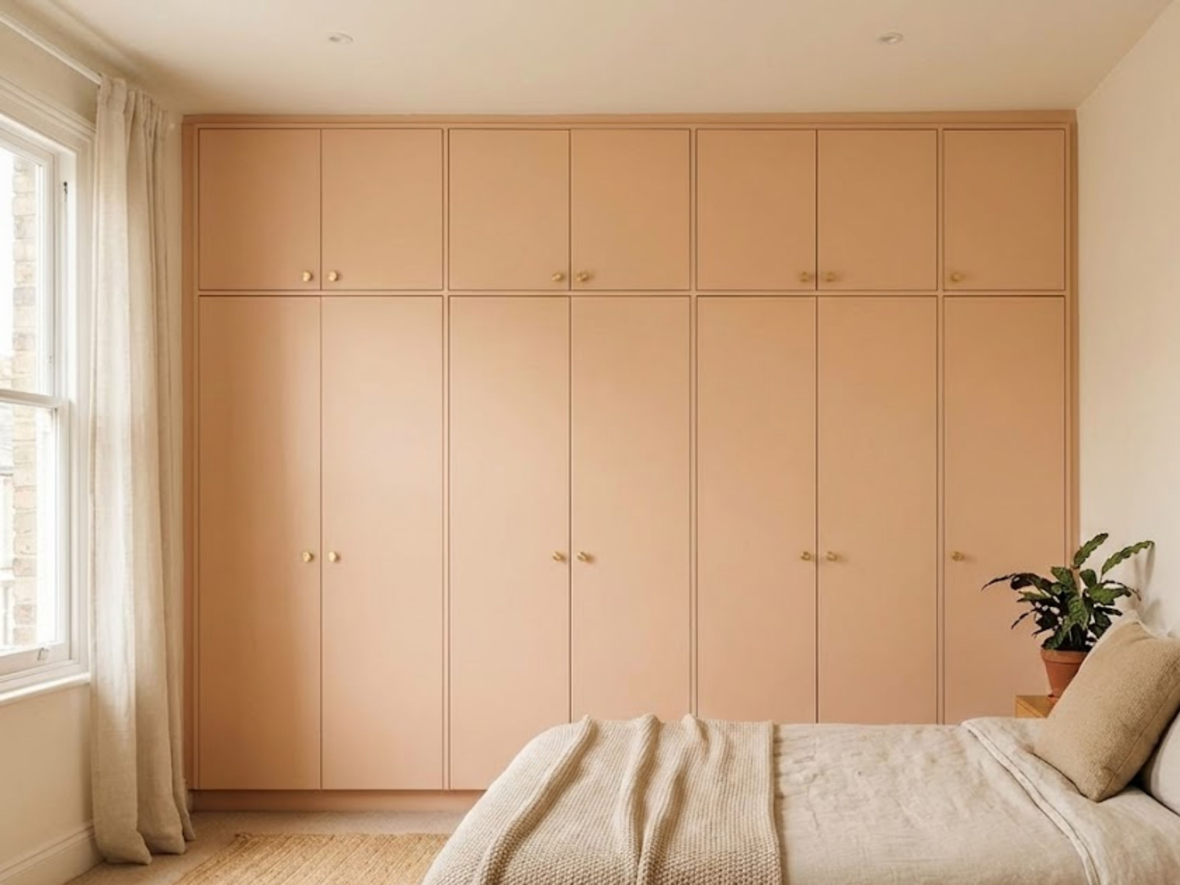 Modern pastel wardrobe with golden handles in bedroom - Beautiful Homes