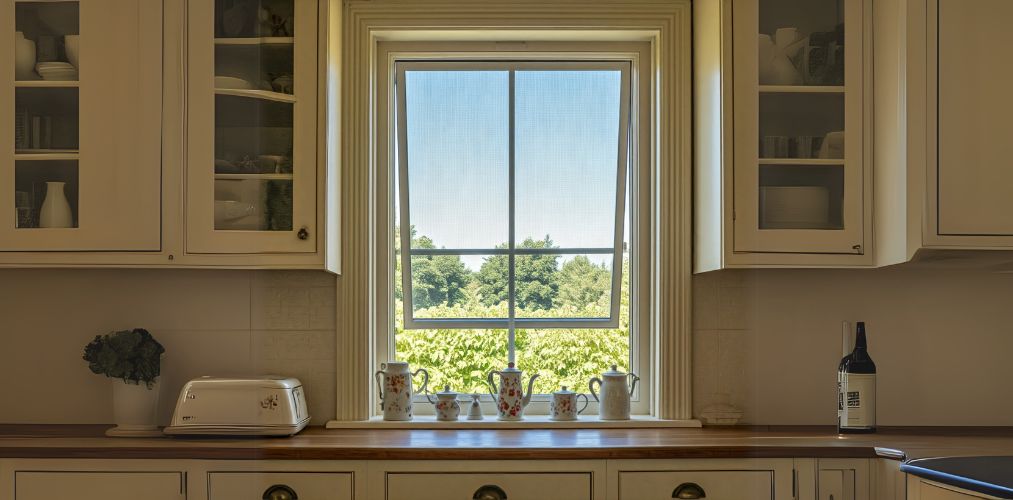 Awning window design in a cream kitchen - Beautiful Homes