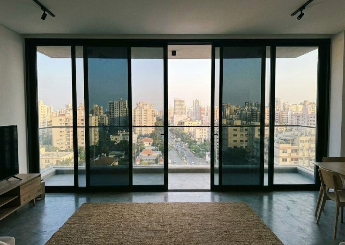 Urban balcony with glass panels and city view - Beautiful Homes