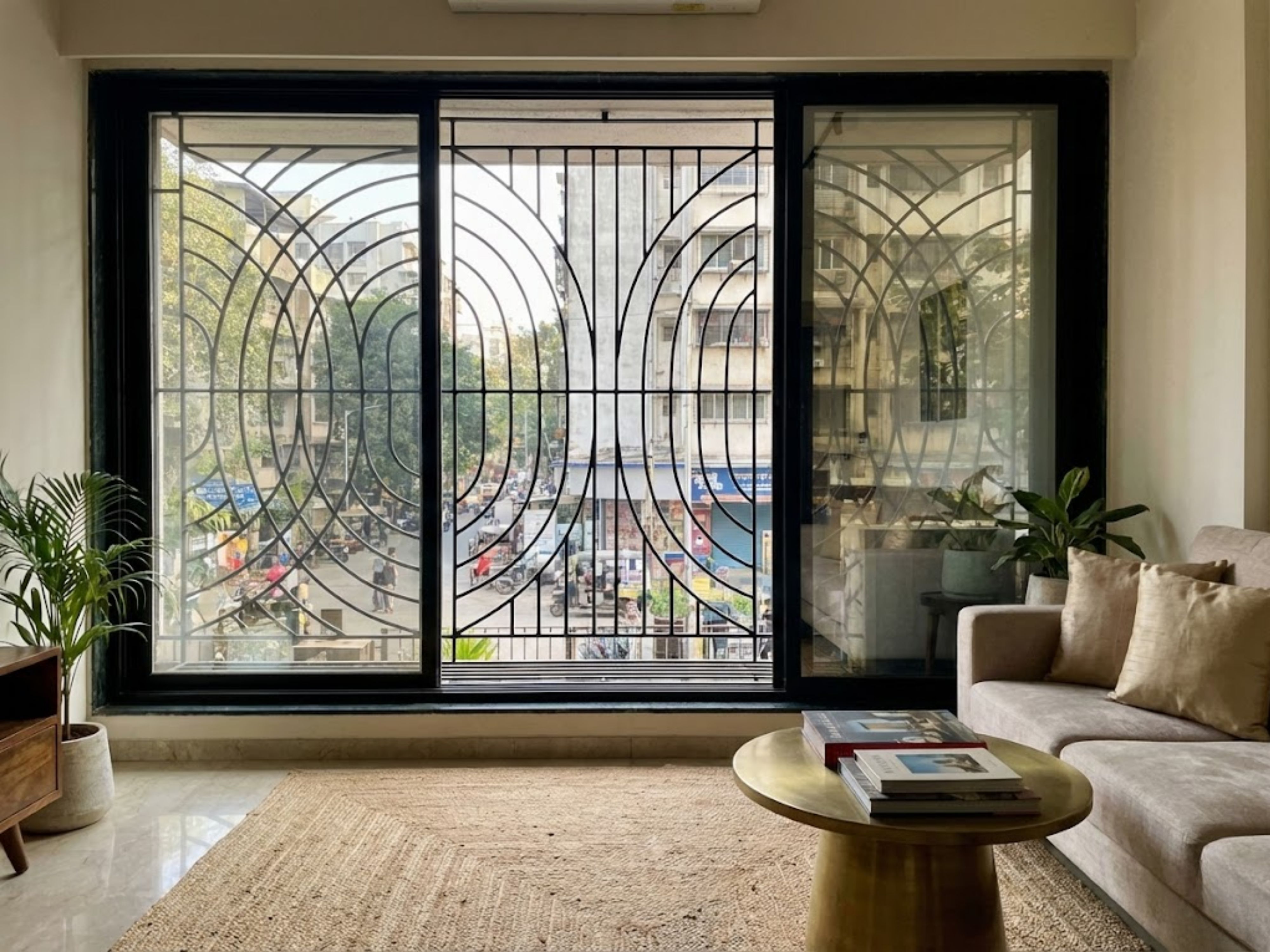 Modern balcony with artistic grill and cozy décor - Beautiful Homes