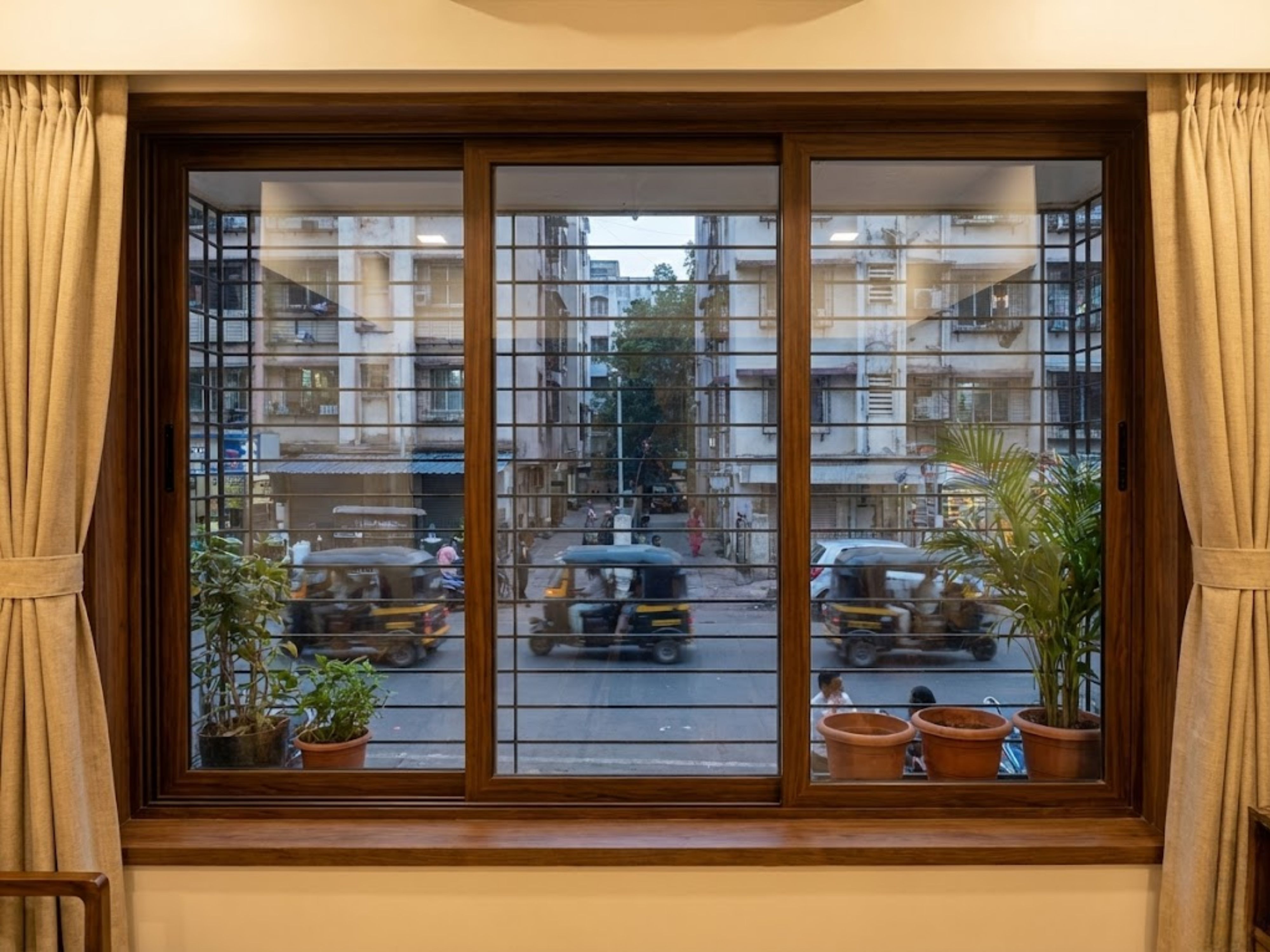 Balcony window with grill and potted plants - Beautiful Homes