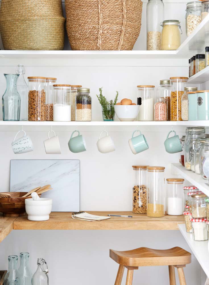 Add hooks to the kitchen shelves to hang your ceramics for an organized kitchen design - Beautiful Homes 
