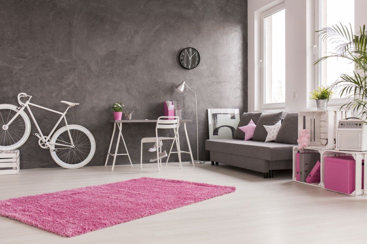 A room decorated with pink décor accessories and concrete walls - Beautiful Homes