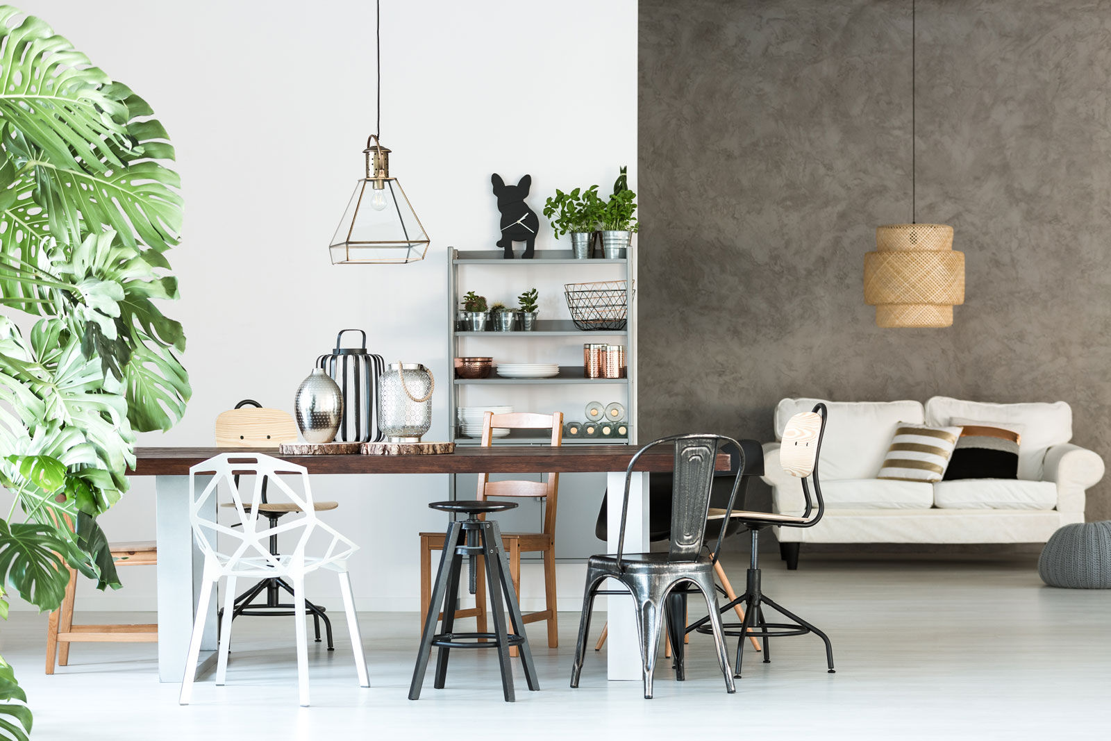 A living room walls with the concrete finish  complement the simple white walls of the dining area - Beautiful Homes