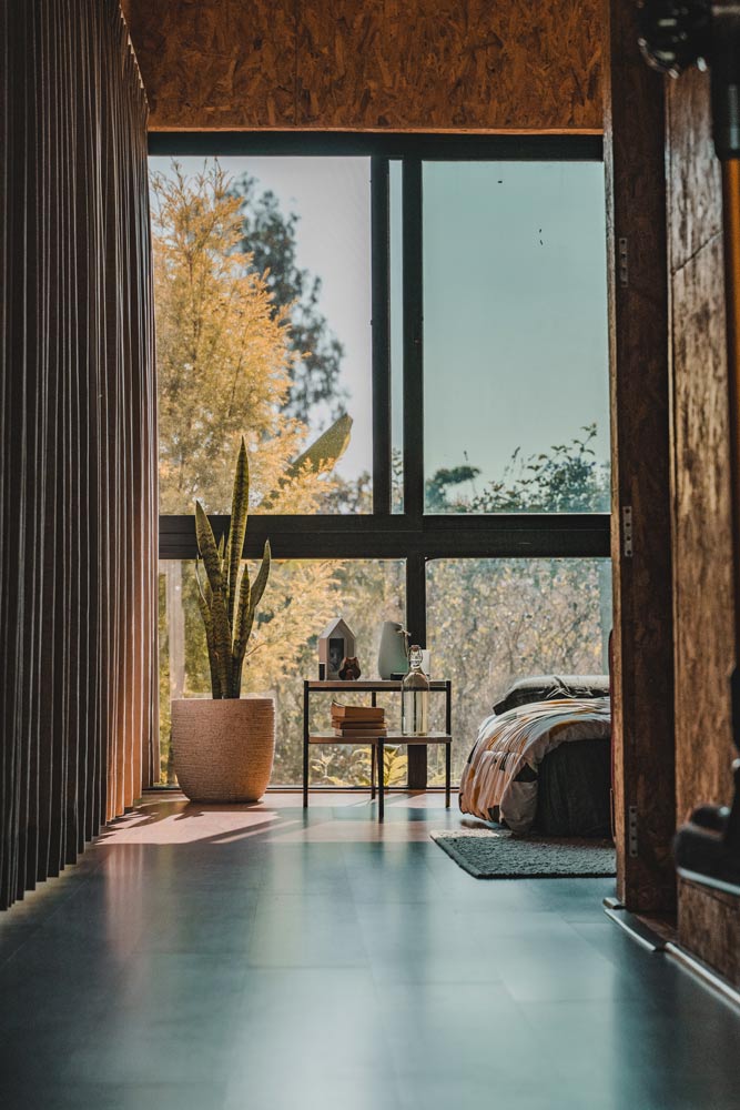 A room with Large windows and a bed