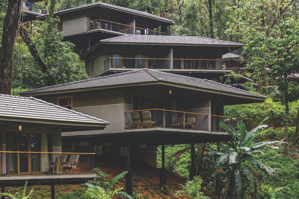 Similar grey houses built next to each other on a mountain slope