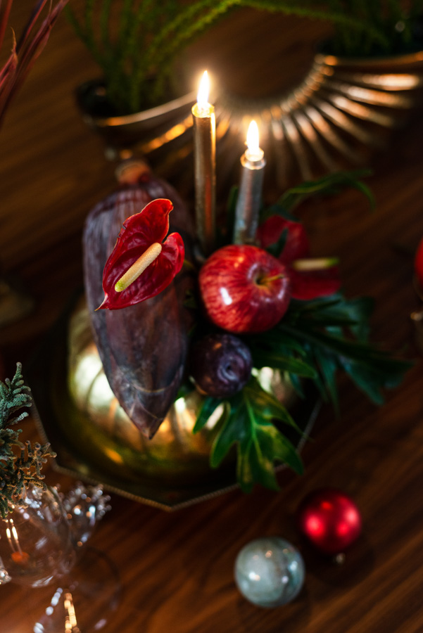 a table decoration by using Eucalyptus leaves, table palms and Monstera leaves