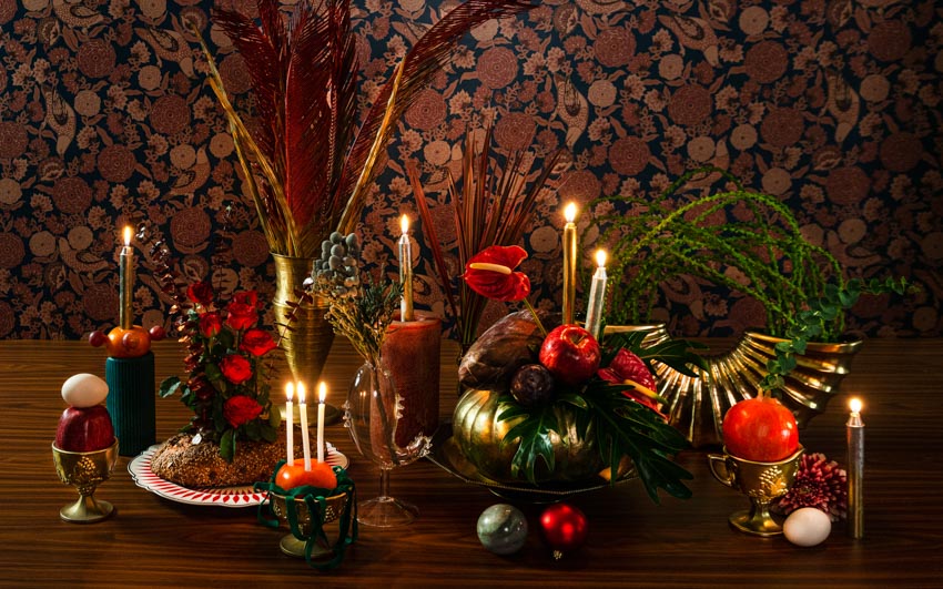 A Christmas table decoration with local flowers & fruits
