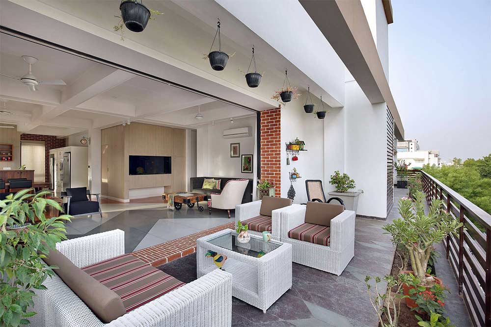Open balcony design with sofa arrangement & plant décor - Beautiful Homes