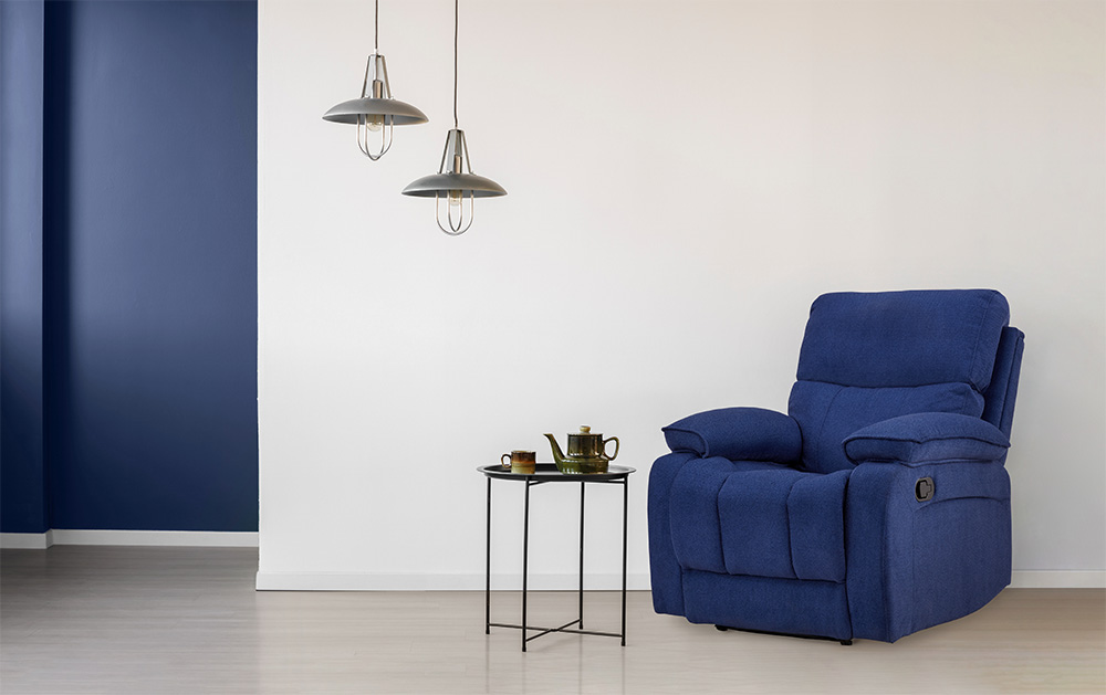 Blue recliner with hanging lights in front of white walls - Beautiful Homes