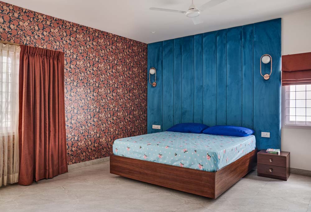 Chennai bedroom with blue headboard & floral wallpaper for bedroom decoration - Beautiful Homes