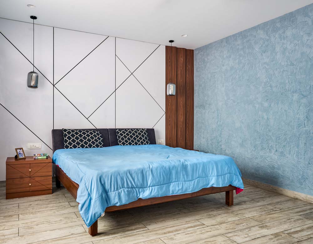 Chennai bedroom design with textured wall & geometric accent panels - Beautiful Homes