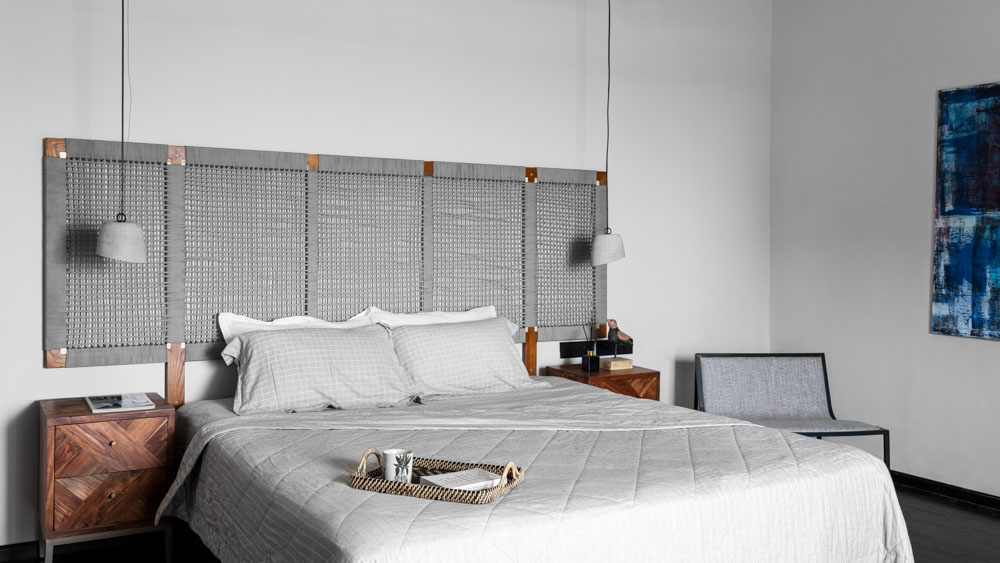 Grey interiors in Chennai with concrete pendant lights & weave pattern headboard - Beautiful Homes