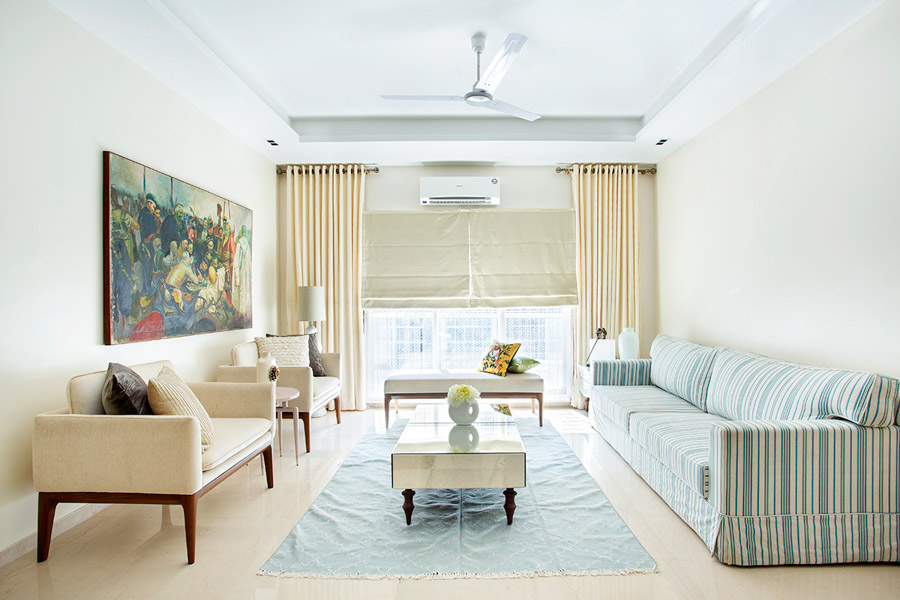 Floor-to-ceiling curtain design covering entire wall and sheer drapes behind them letting a lot of light in