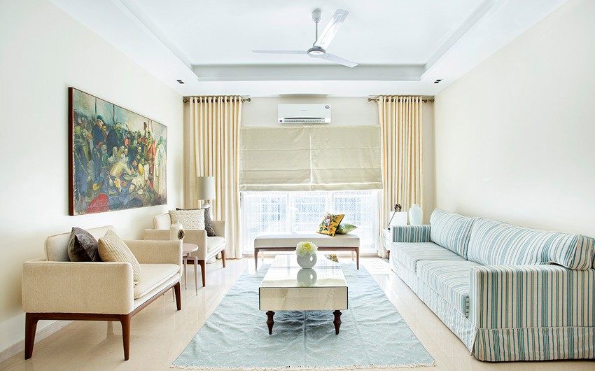 Floor-to-ceiling curtain design covering entire wall and sheer drapes behind them letting a lot of light in