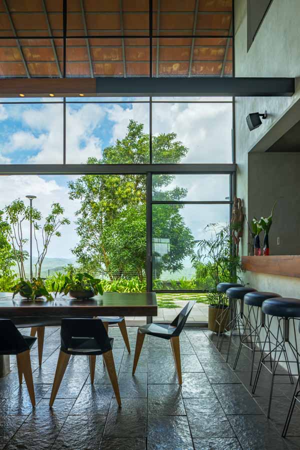 A dining room with big windows and a view of mountains