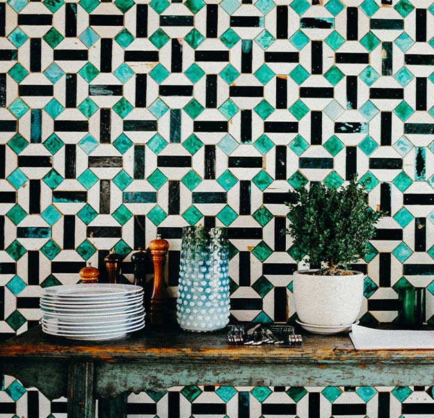 A wall fitted with green and white tiles