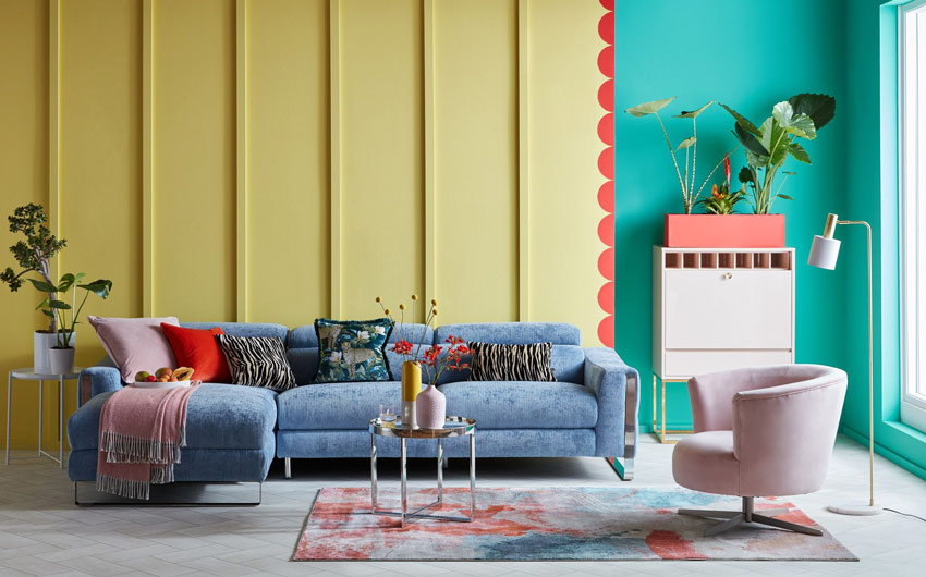 A yellow and green living room with a blue sofa
