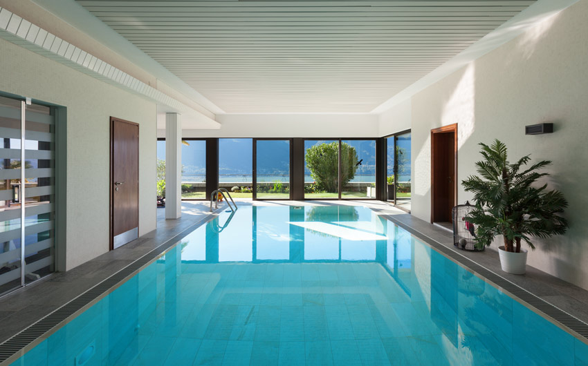 Install glass doors to welcome natural sunlight into your indoor swimming pool - Beautiful Homes