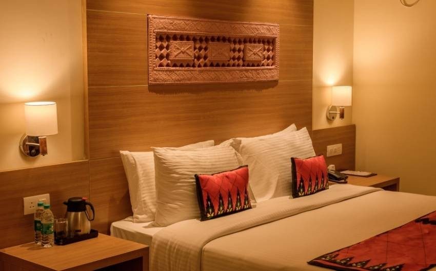 Indian living room design with armchair, sectional sofa & patterned cushions - Beautiful Homes