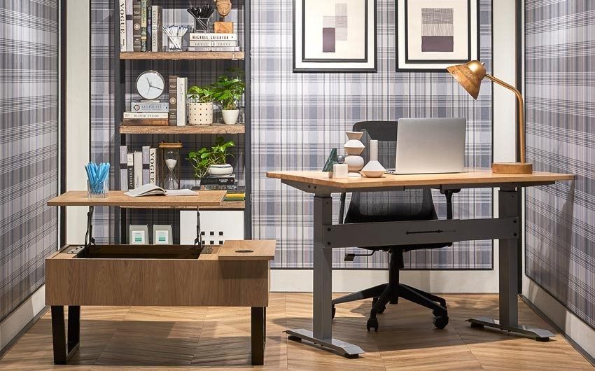 A study area with chequered wallpaper and two desks placed next to each other