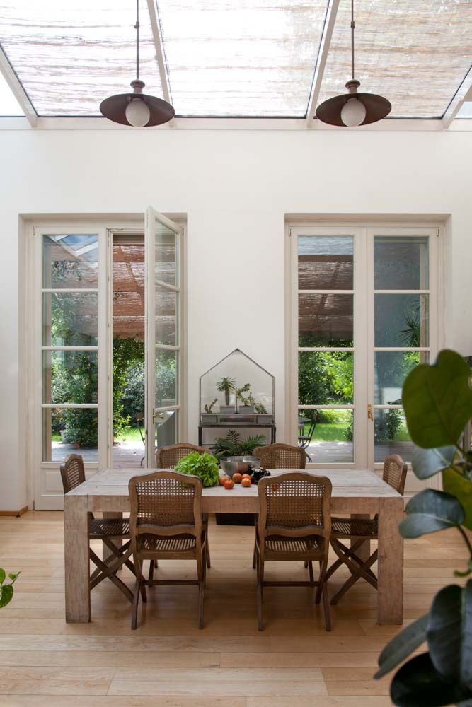 Room design with white french door design & wooden flooring & indoor plants - Beautiful Homes