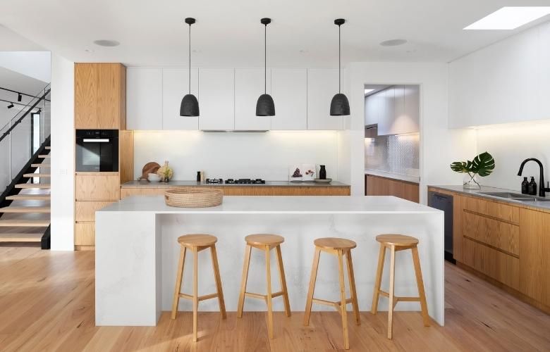 Wooden L-shape kitchen design with kitchen island as breakfast counter - Beautiful Homes