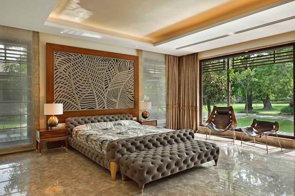 Modern bedroom design with bed that has a tufted upholstery finish matching with bedroom décor - Beautiful Homes