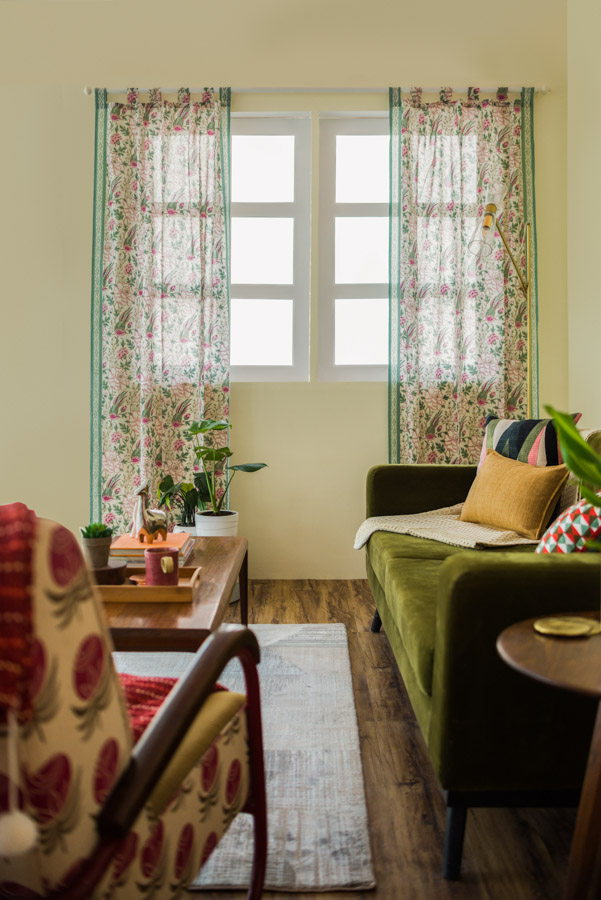 Living Room Design With White Framed Window With Floral Curtains, Green Sofa, A Rug & Coffee Table - Beautiful Homes