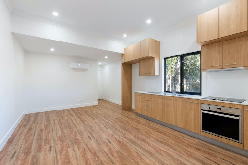 Spacious straight modular kitchen with laminate finish kitchen cabinets & wooden flooring - Beautiful Homes