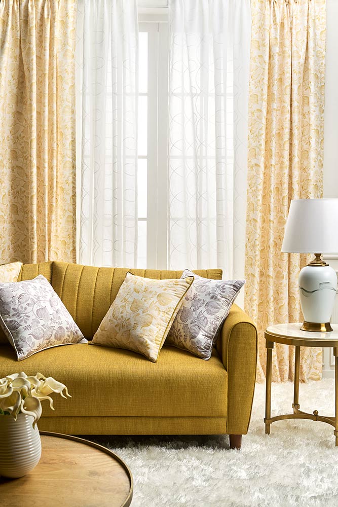 Living room with a sofa, cushions, and curtains