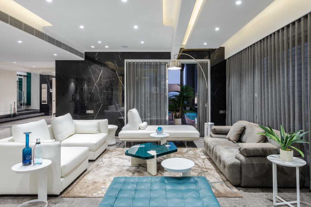 Black marble wall design with white & grey couches - Beautiful Homes